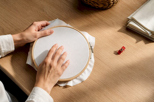Hands testing embroidery hoop fabric tension