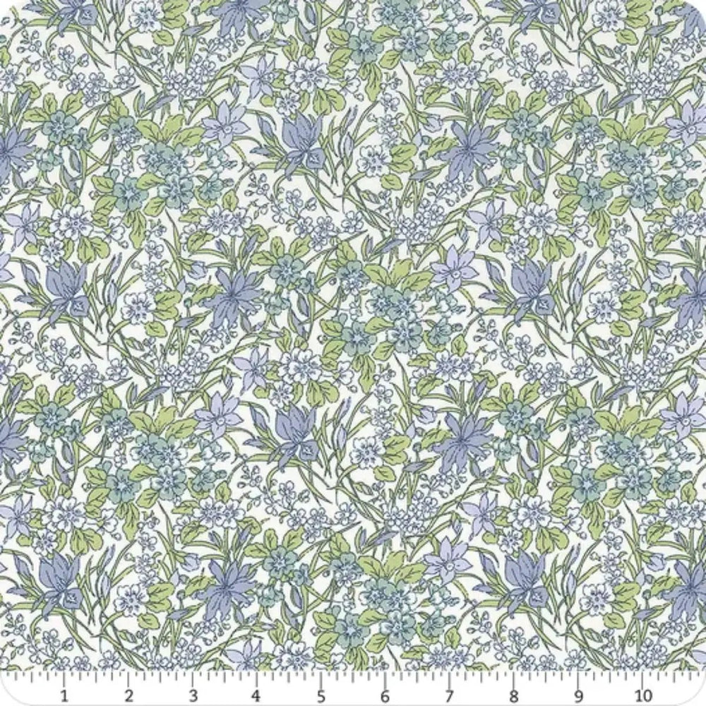 Everlasting Ricardo A quilting cotton fabric featuring delicate blue flowers, green foliage, and scattered botanical motifs on a light background.