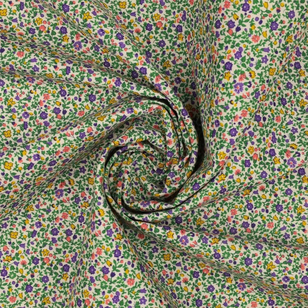 Everlasting Posy Haze A quilting cotton fabric with tiny purple, yellow, pink, and green floral motifs on a light background.