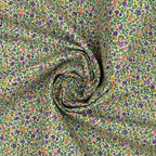 Everlasting Posy Haze A quilting cotton fabric with tiny purple, yellow, pink, and green floral motifs on a light background.