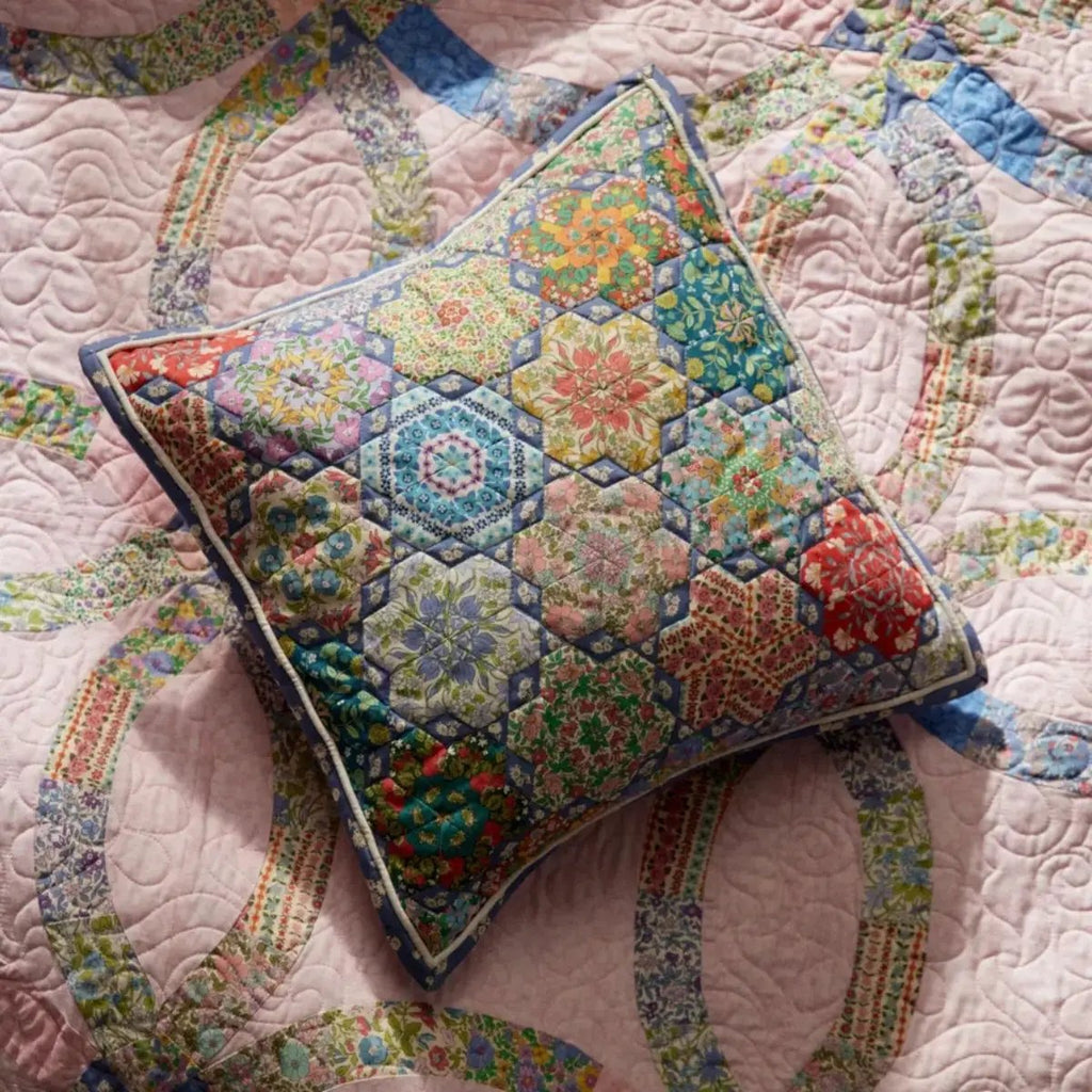 Everlasting Posy Haze A quilting cotton fabric with tiny purple, yellow, pink, and green floral motifs on a light background.