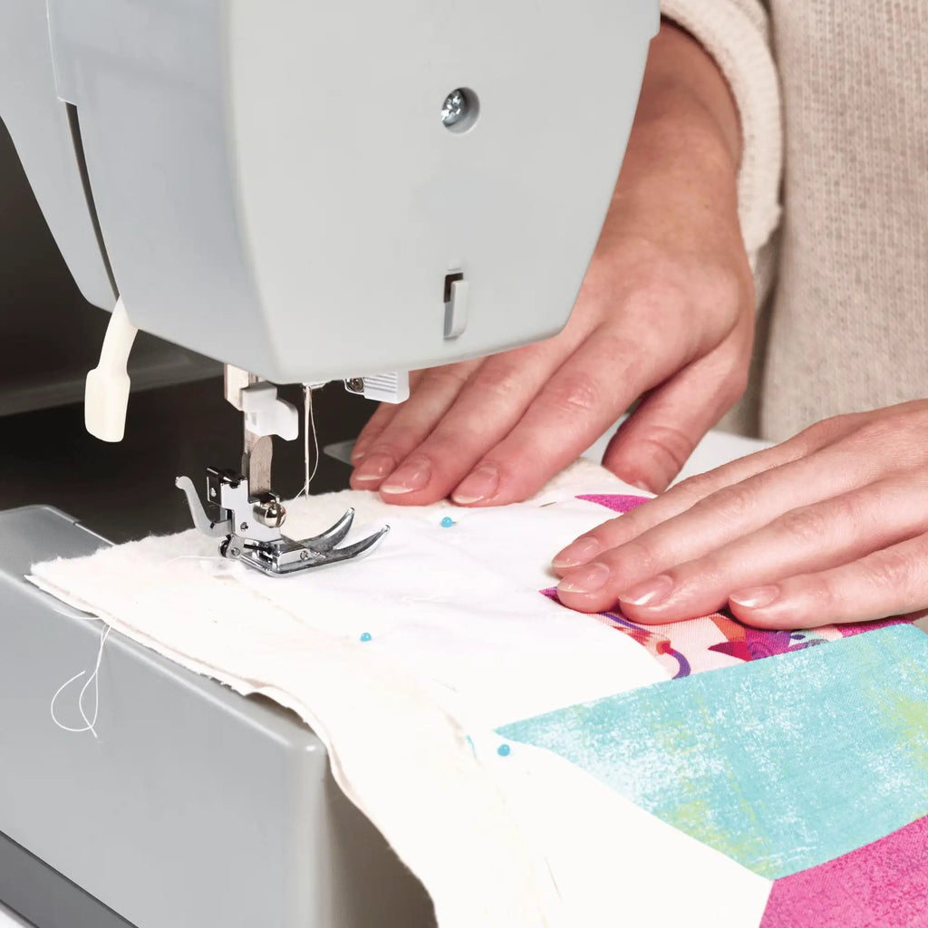 Warm & Natural Cotton Batting Twin 72x90 precut; white batting being sewn under a presser foot