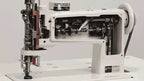 Consew 104-10T single-needle chainstitch industrial sewing machine, white with universal feed movement.