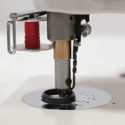 Consew 104-10T industrial sewing machine needle area with a red thread spool