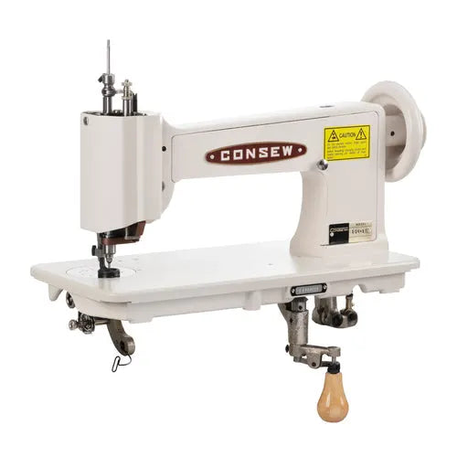 Consew 104-1T single-needle industrial sewing machine on a white assembled table with servo motor