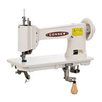 Consew 104-1T single-needle industrial sewing machine on a white assembled table with servo motor