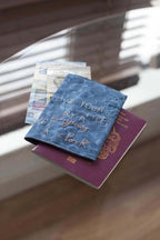 Threaders Embroidery Transfer Sheets Traveller: blue embroidered passport cover atop a purple passport