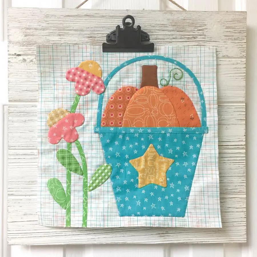 Autumn Love Sew Along Kit by Riley Blake Designs: blue star-patterned basket with orange pumpkins