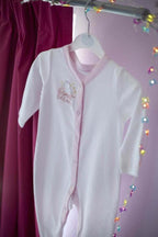 Threaders Embroidery Transfer Sheets - Baby: white baby onesie with pink trim on a hanger, embroidered chest.