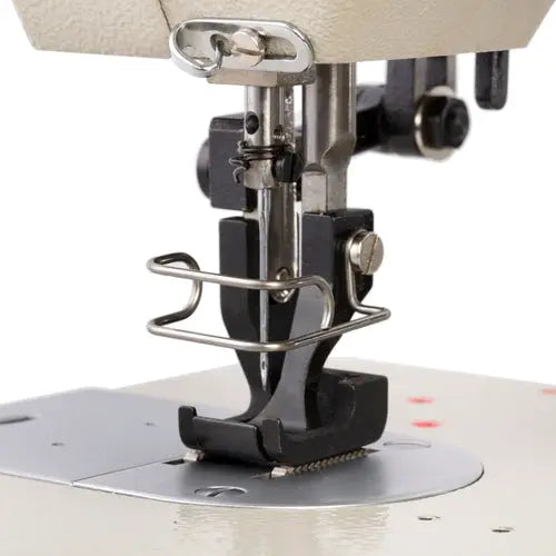 Consew 146RB walking-foot sewing machine close-up of needle area, beige body and metal presser foot.