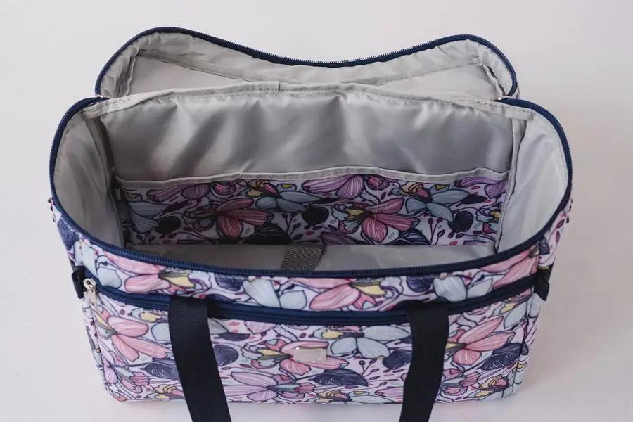 Bluefig Quilter Essential Combo 19in wheeled bag in Maisy floral print with navy handles.