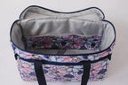 Bluefig Quilter Essential Combo 19in wheeled bag in Maisy floral print with navy handles.