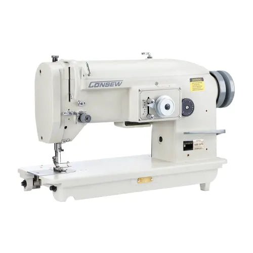 Consew 199R industrial sewing machine with table and motor, cream color, single-needle drop-feed.