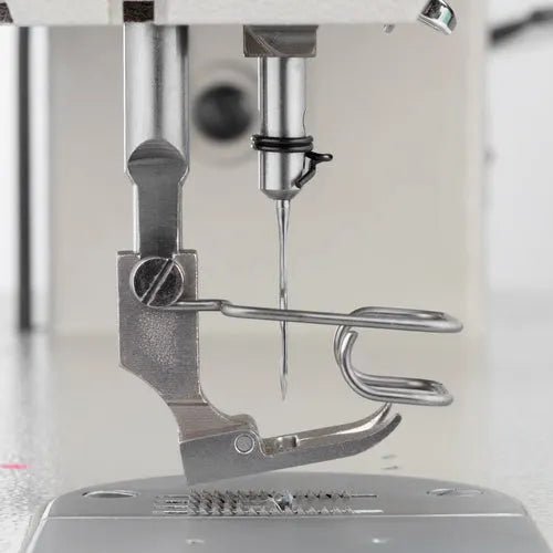 Consew 199RB industrial sewing machine with table and motor; single-needle drop-feed.