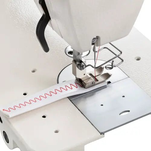 Consew 199RB industrial sewing machine with table and motor; white, single-needle, drop-feed.