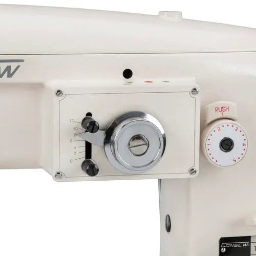 Consew 199RB single-needle industrial sewing machine head, white with table and motor.