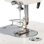 Consew 199RB industrial sewing machine with table and motor, white body and metal presser foot.