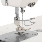 Consew industrial sewing machine 199RB single-needle drop-feed with table and motor, silver body.