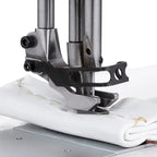 Consew 2040 industrial sewing machine close-up of walking foot stitching fabric on a metal table