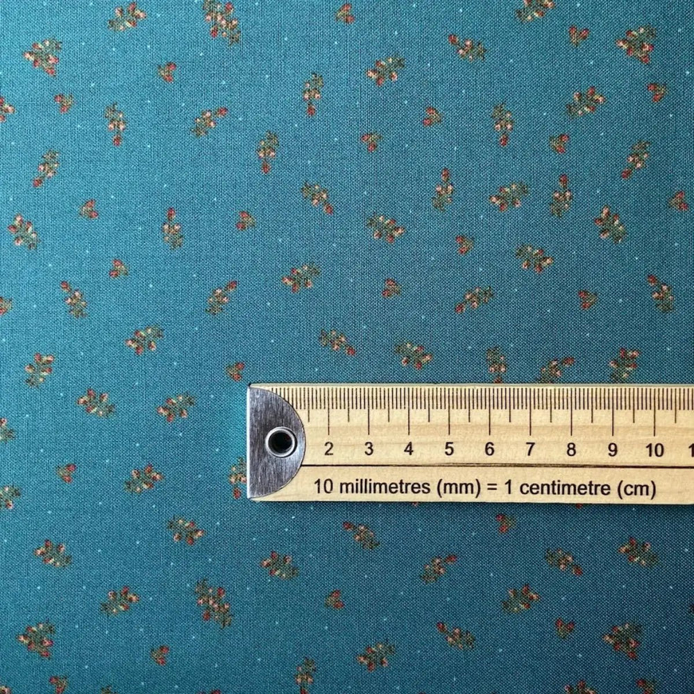 The Magical Garden Little Rose Ocean Blue quilting fabric with red and cream rosebuds and green leaves by Sarah J Patterson