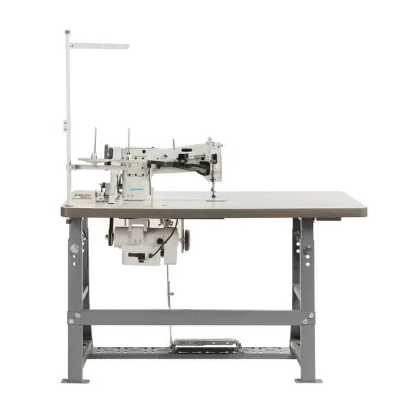Consew 206RB-5 walking-foot upholstery sewing machine on table with stand and 110V servo motor