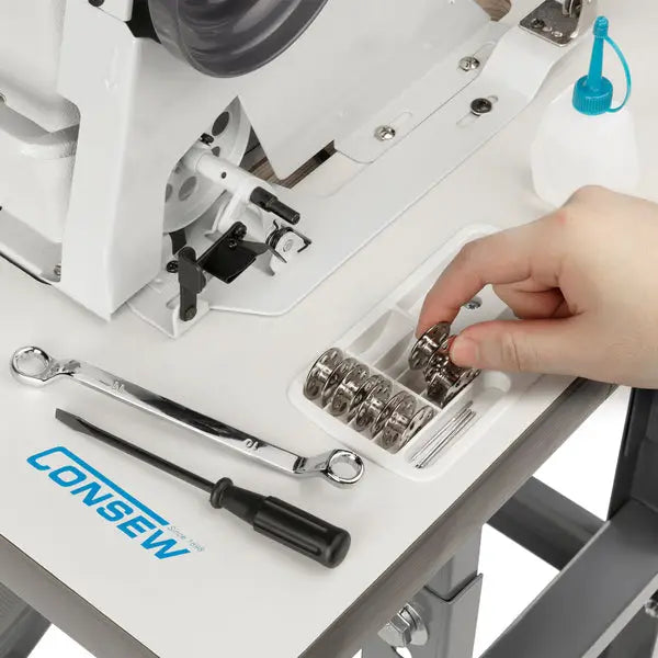 Consew 206RB-5 walking-foot upholstery sewing machine, white; table, bobbins tray, and tools