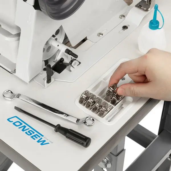Consew 206RB-5 walking-foot upholstery sewing machine, white; table, bobbins tray, and tools