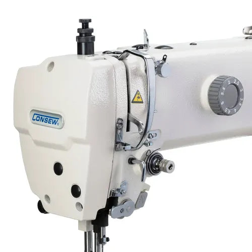 Consew sewing machine head, cream-colored with metal components and visible logo plate