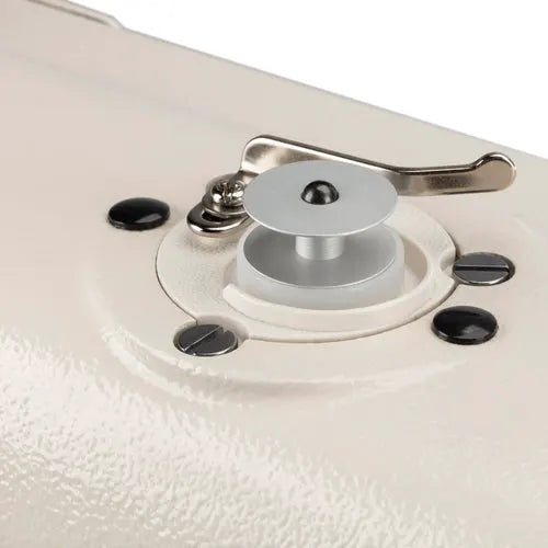 Sewing machine presser foot lifter on beige machine surface