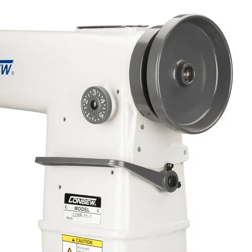 Consew 228R-11-1 industrial sewing machine, white body with large gray handwheel and label