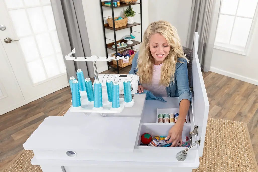 Koala Serger Studio sewing machine extension table in white with blue thread spools and storage