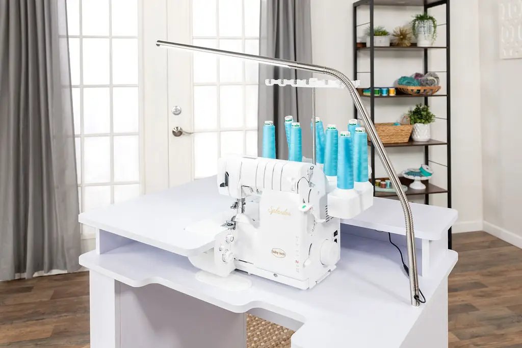 Koala Serger Studio on white sewing extension table with six blue thread spools.