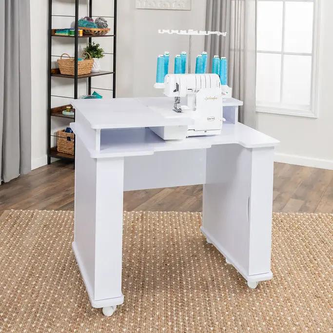 Koala Serger Studio white sewing machine extension table with casters and thread spools.