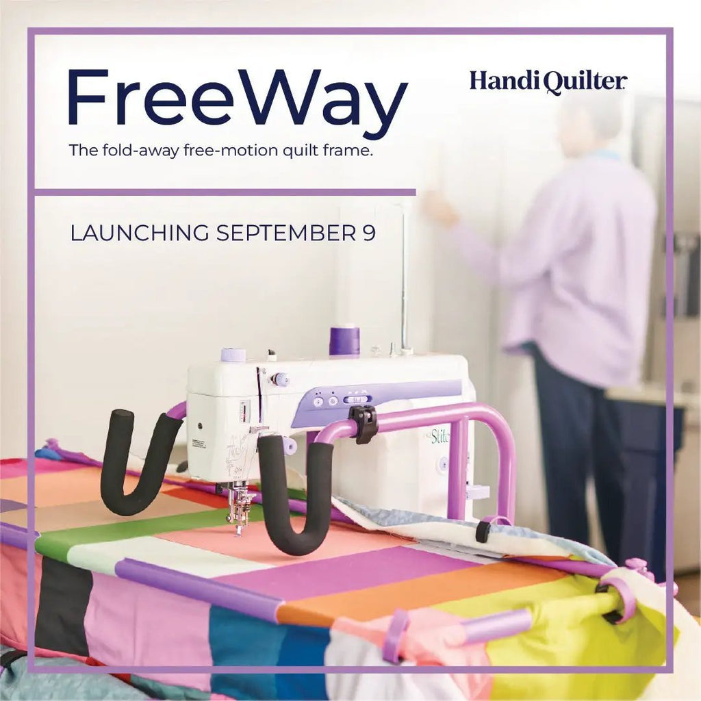 Handi Quilter FreeWay Quilt Frame in purple with a white machine on a bright multicolor quilt