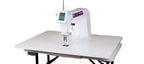 Pfaff PowerQuilter 16.0 long-arm quilting machine on a white table