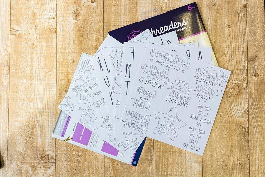 Threaders Embroidery Transfer Sheets - Baby, 6-pack; white sheets shown with Threaders packaging