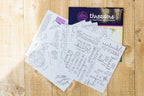 Threaders Embroidery Transfer Sheets Traveller; several white design sheets with printed motifs and Threaders packaging.