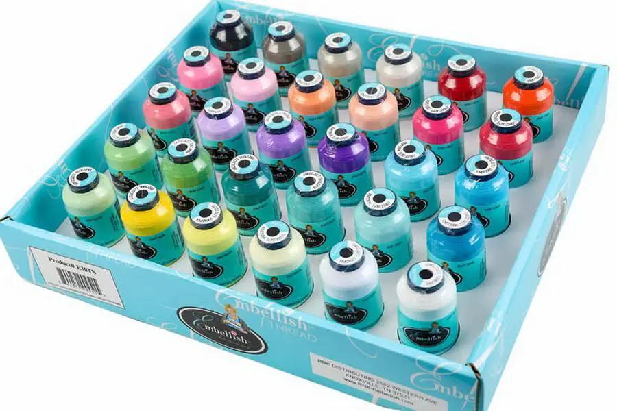 Floriani Embellish Matte Thread Kit inspired by Hope Yoder in a blue display box with rows of colorful thread spools