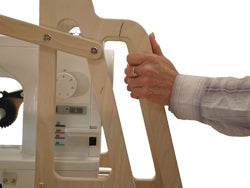 Person holding a wooden frame against