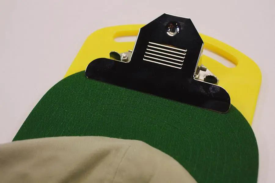 DIME Magnetic Hoop Clip with yellow base and black metal clip securing a green hoop