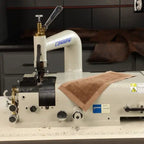Consew DCS-S4 skiving machine with assembled table and servo motor; beige unit with blue Consew logo.