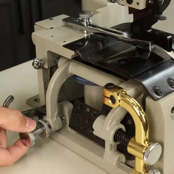 Consew DCS-S4 skiving machine with assembled table and servo motor, beige body with brass guard.