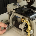 Consew DCS-S4 skiving machine with assembled table and servo motor, beige body with brass guard.
