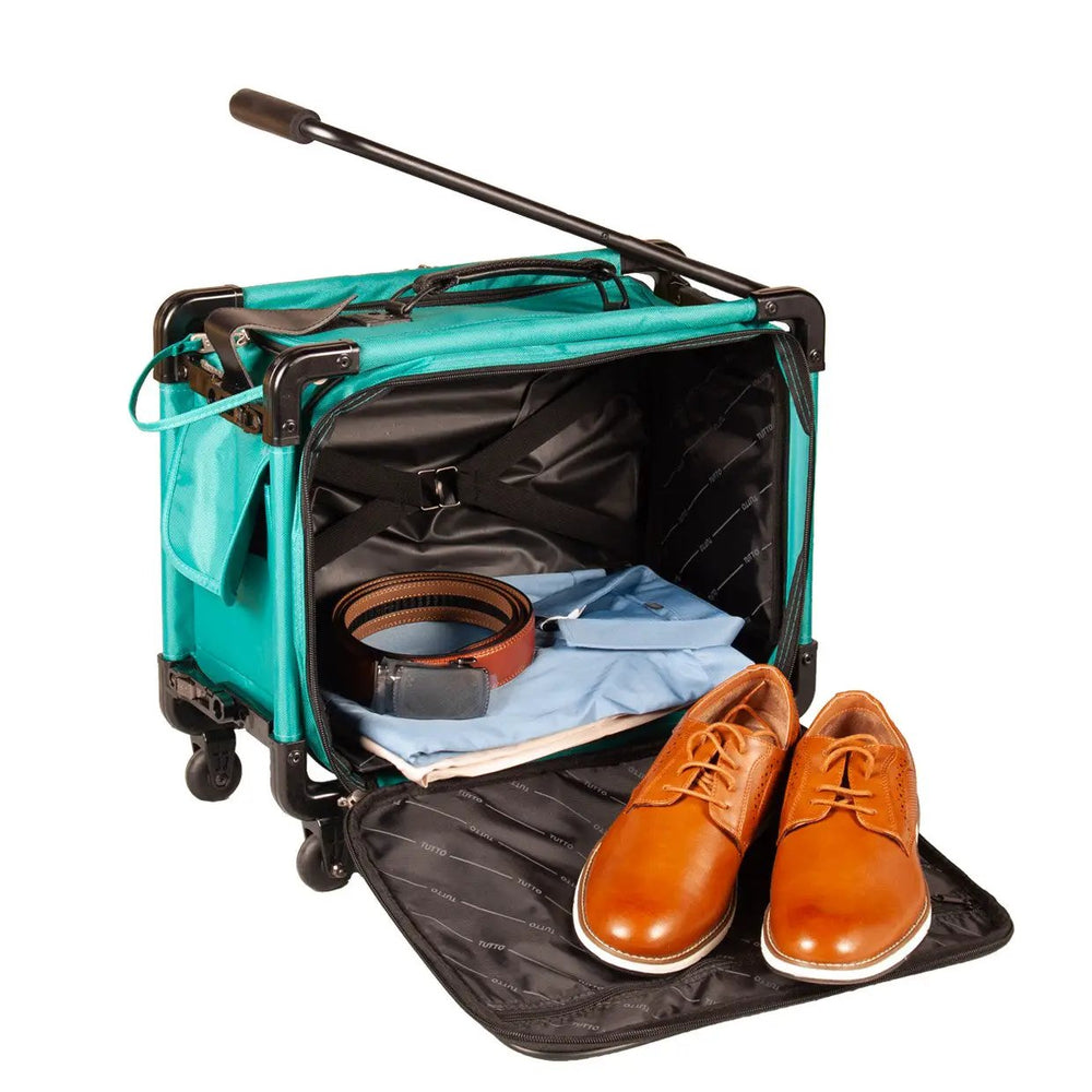 Tutto turquoise 17-inch carry-on luggage on wheels, opened to reveal clothes, a belt and brown leather shoes