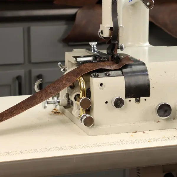 Consew DCS-S4 skiving machine, beige unit with assembled table and servo motor, brown leather strap.