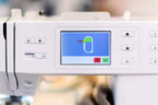 Bernette B59 sewing and embroidery machine control panel, white with color touchscreen display.