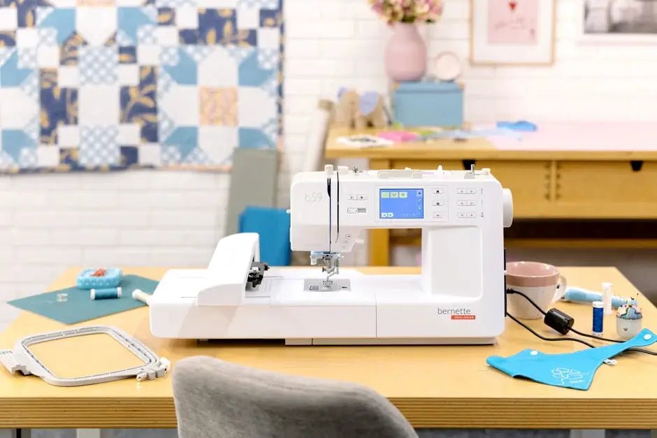 Bernette B59 Sewing and Embroidery machine, white with digital display on a wooden desk