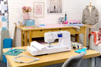 Bernette B59 sewing and embroidery machine, white, on a wooden craft table in a bright room