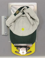 DIME Magnetic Hoop Clip HC00100; yellow base metal clip holding a beige cap with dark green brim on a gray surface