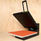 Ricoma high-pressure heat press with orange platen on a black metal frame and lift handle